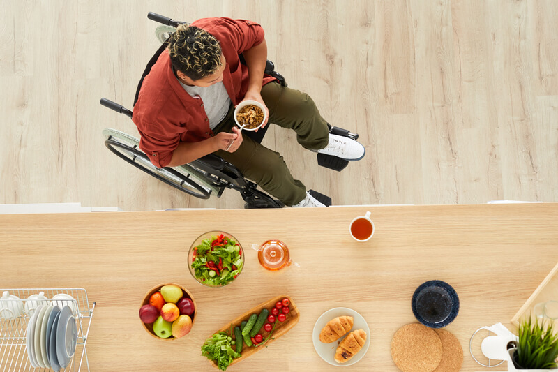 Wheelchair User Eating Breakfast in the Kitchen