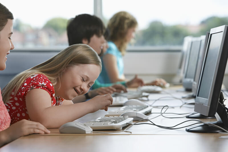 Young girl using a computer at school