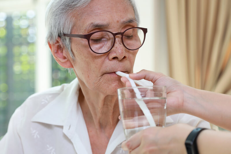 Woman sipping from a straw